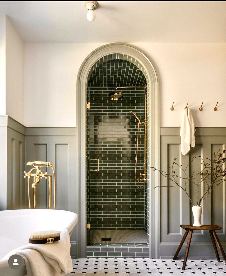 a white bath tub sitting next to a walk in shower