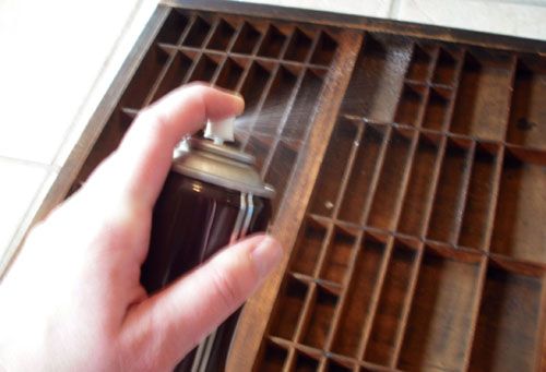 a person is holding a lighter in front of a grate on the floor with it's mouth open