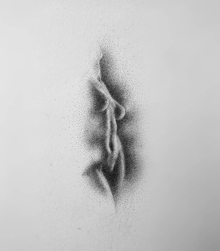 a black and white photo of a person's body in the air with drops of water on it