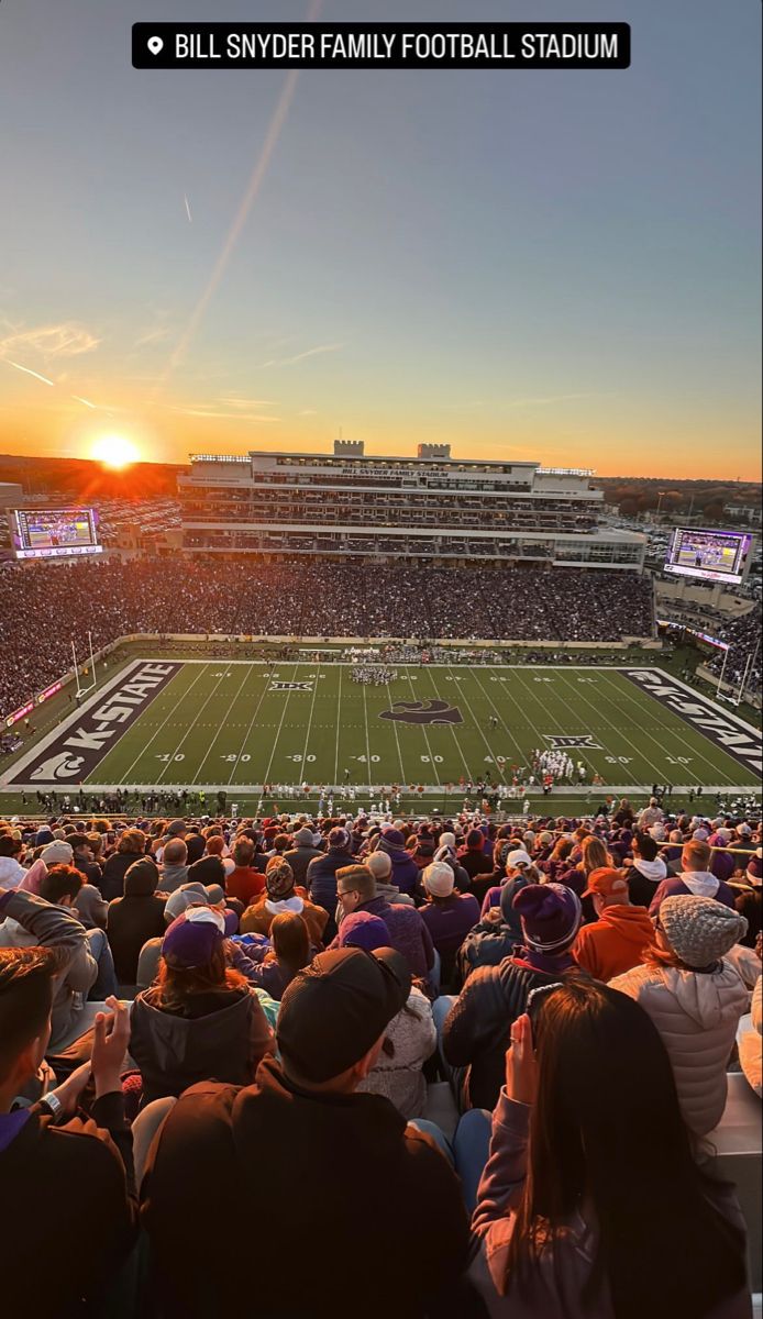 the sun is setting over an empty football stadium as people sit on the bleachers