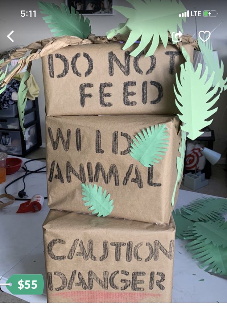 two cardboard boxes that say i don't feed wild animal, caution danger and do not feed the animals