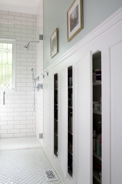 a bathroom with white walls and tile flooring next to a walk - in shower