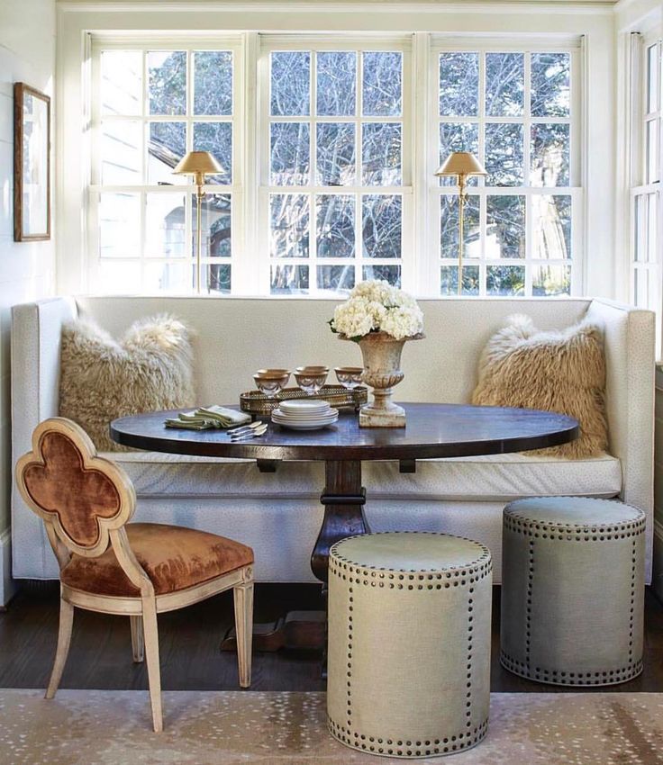 a living room filled with furniture next to a table and two chairs on top of a hard wood floor