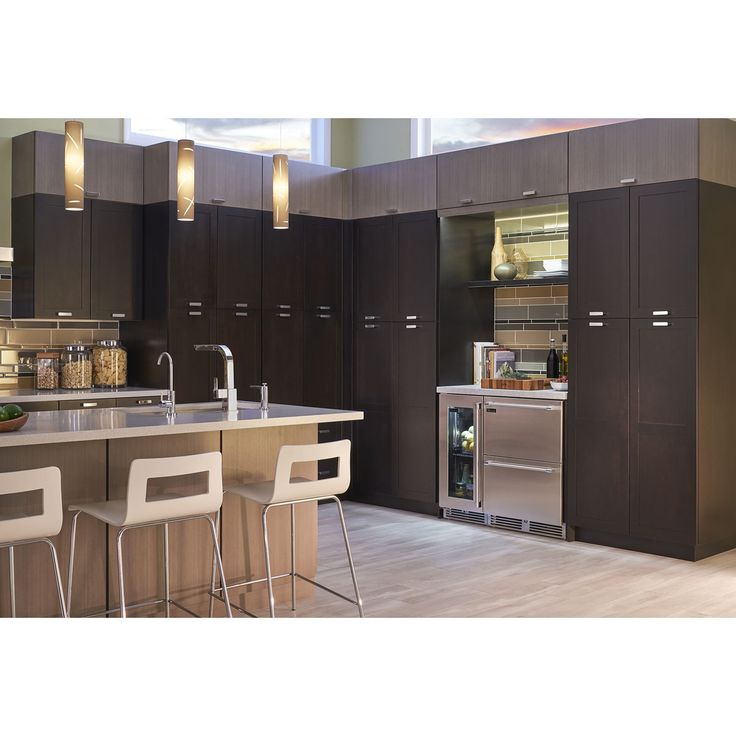 a modern kitchen with stainless steel appliances and bar stools