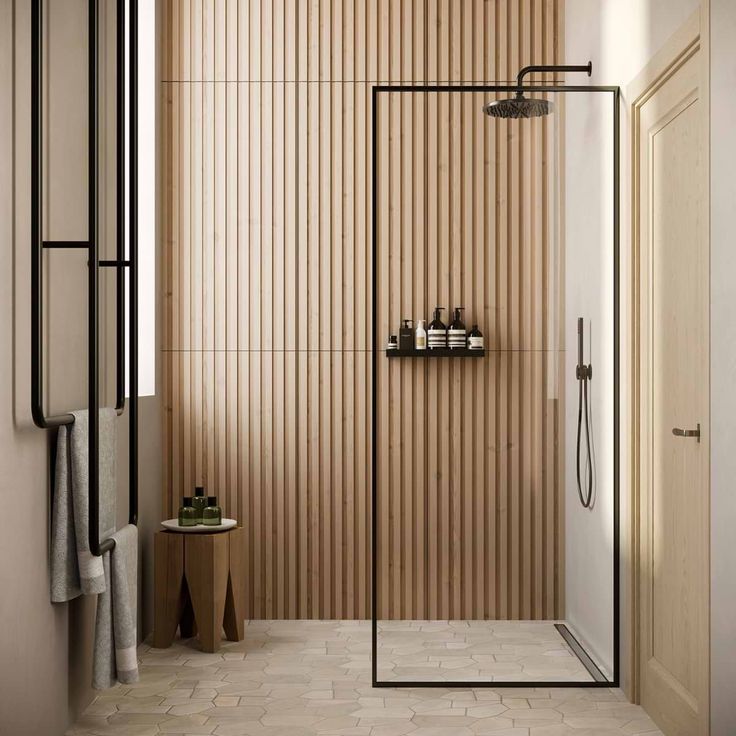 a bathroom with wooden walls and flooring next to a walk - in shower stall