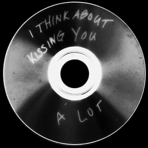 a metal disc with writing on it that says, i think about kissing you a lot