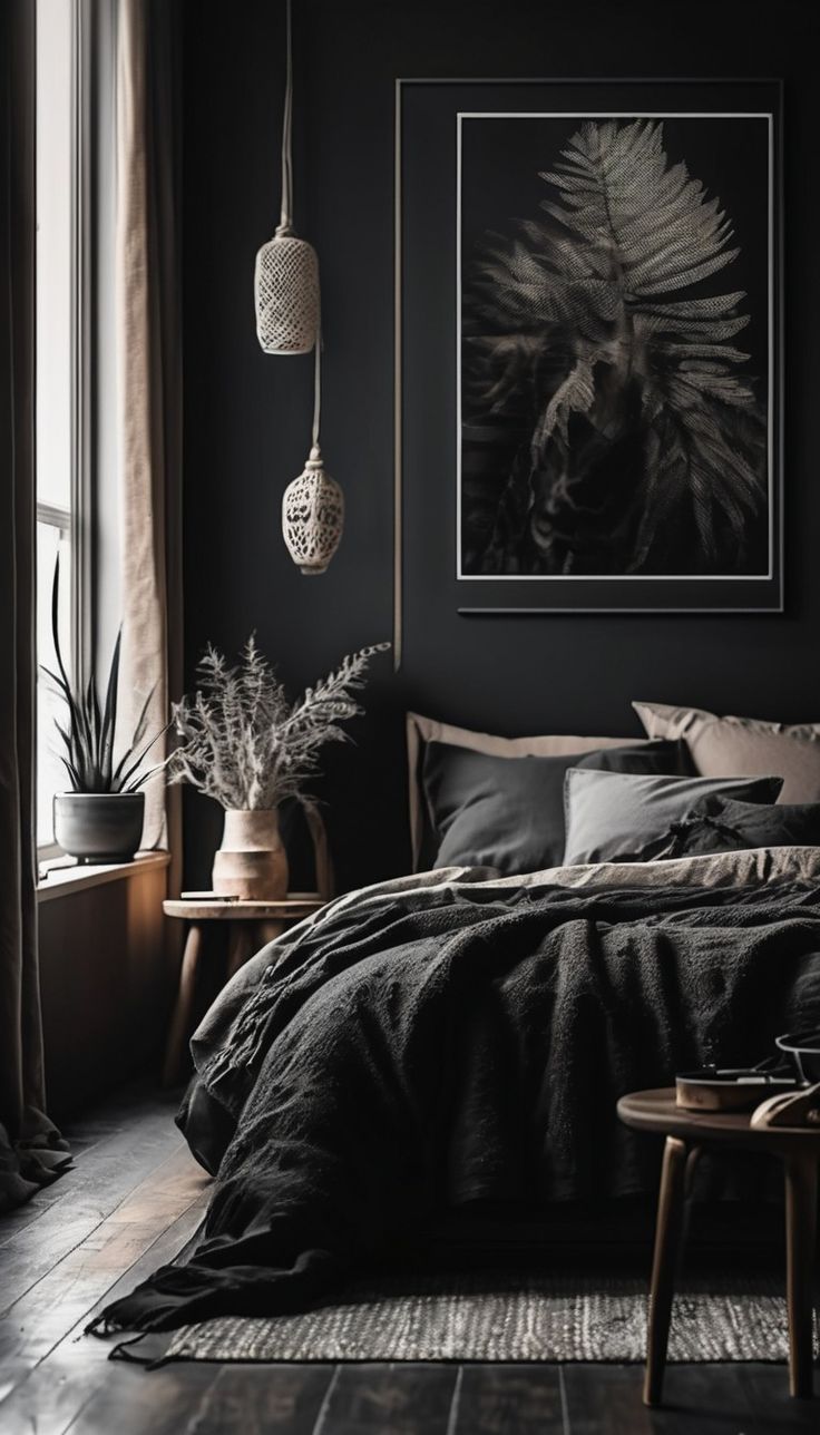 a bedroom with black walls and wooden flooring is pictured in this image, there are plants on the side of the bed