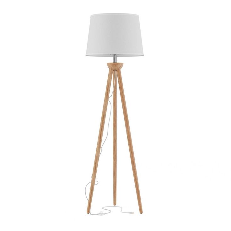 a wooden tripod floor lamp with a white shade on the top and an electric plugged in