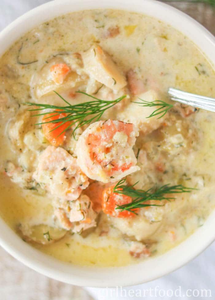 a white bowl filled with shrimp and potato soup