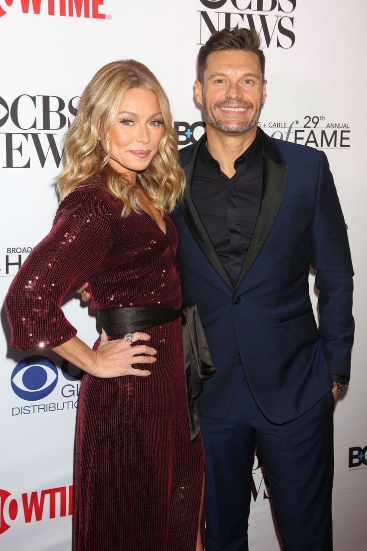 a man and woman standing next to each other on the red carpet at an event