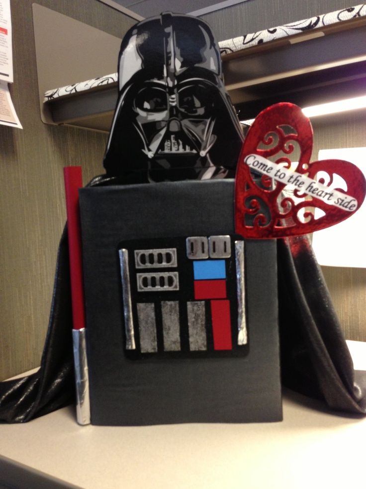 a darth vader box sitting on top of a desk next to a heart