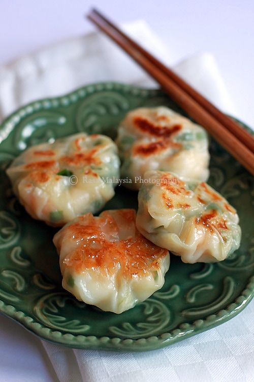 some food on a green plate with chopsticks