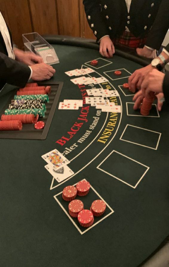 people playing cards at a casino table