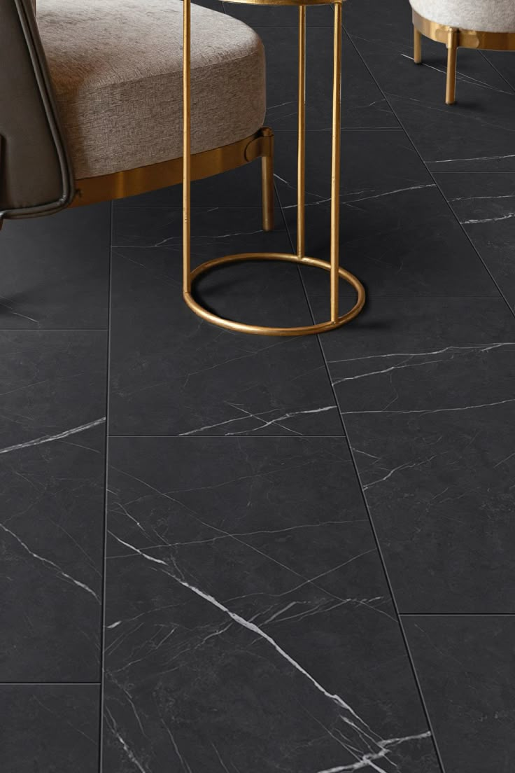 black marble tile flooring in a living room with two chairs and a round table