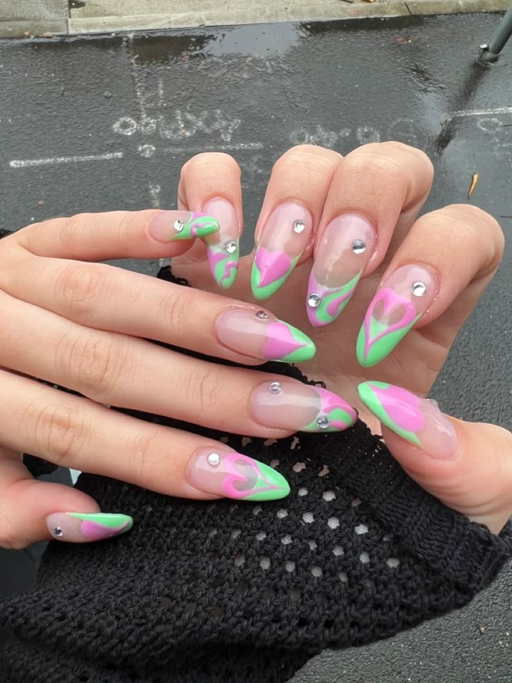 Pink green heart acrylic nails gems Green Almond Acrylic Nails Designs, Pastel Pink And Green Nails Acrylic, Green Nails Fairycore, Green N Pink Nails, Txt Acrylic Nails, Twice Concert Nails, Pink Green And White Nails, Nail Green And Pink, Green And Pink Almond Nails