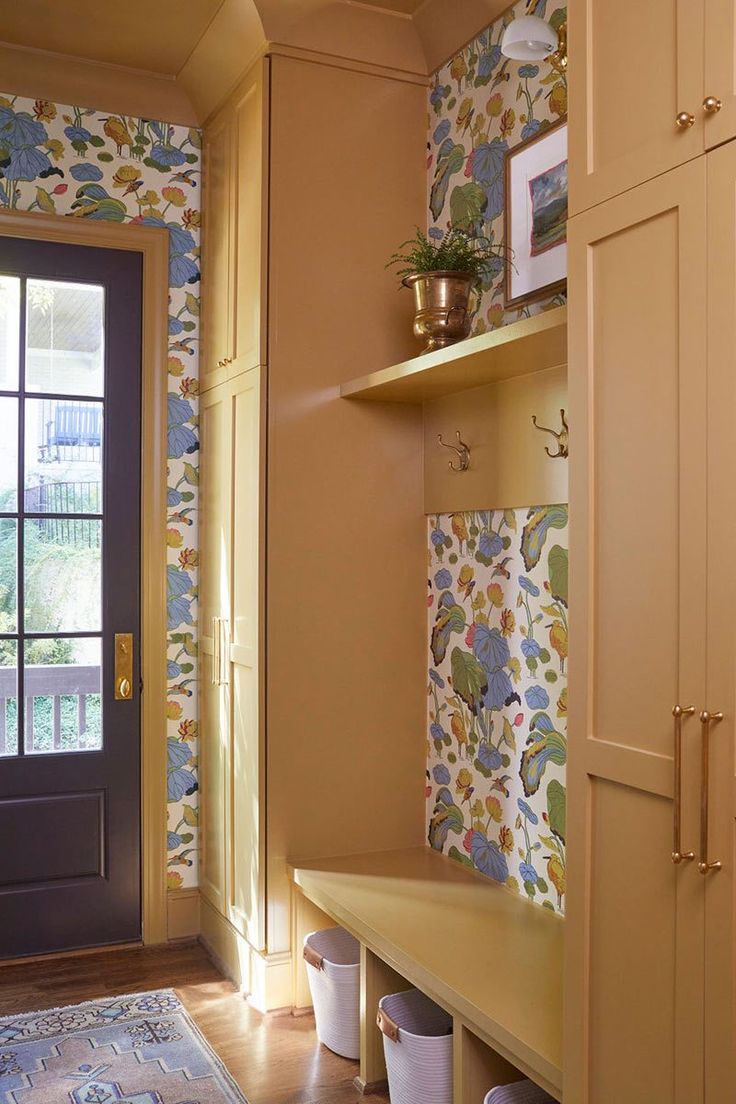 an entryway with wallpaper and wooden flooring