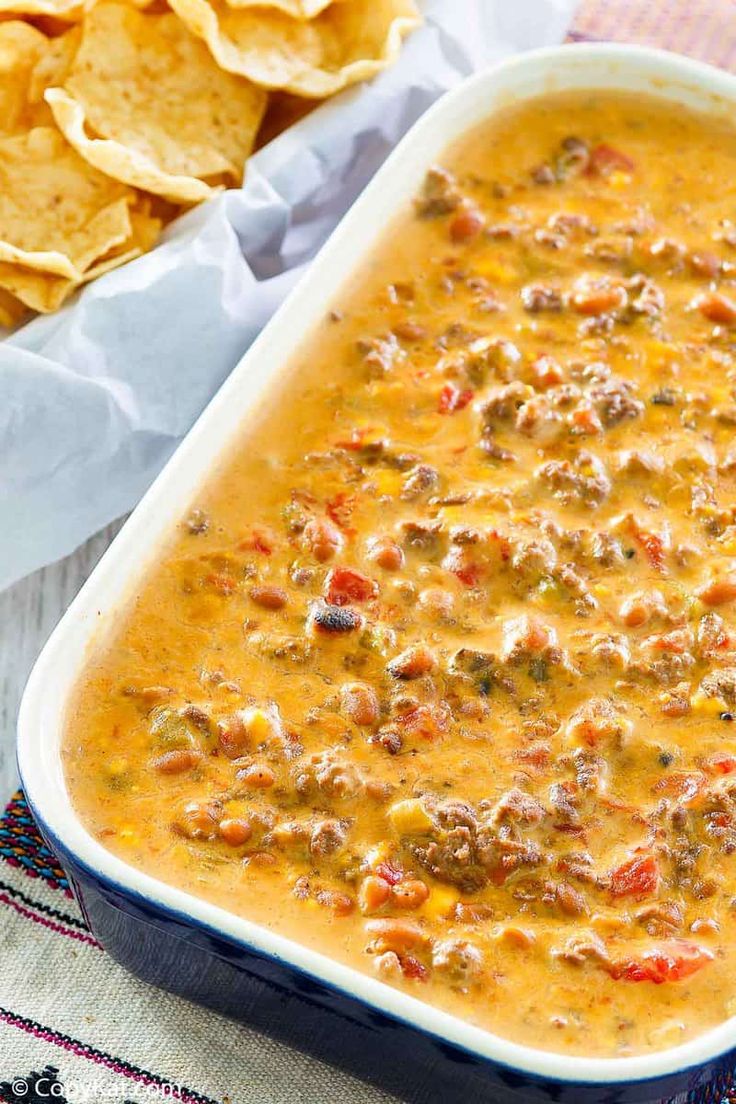 a casserole dish with tortilla chips next to it