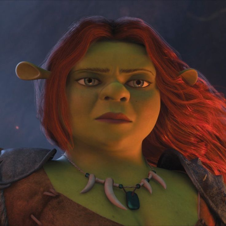 an animated character with red hair and green eyes