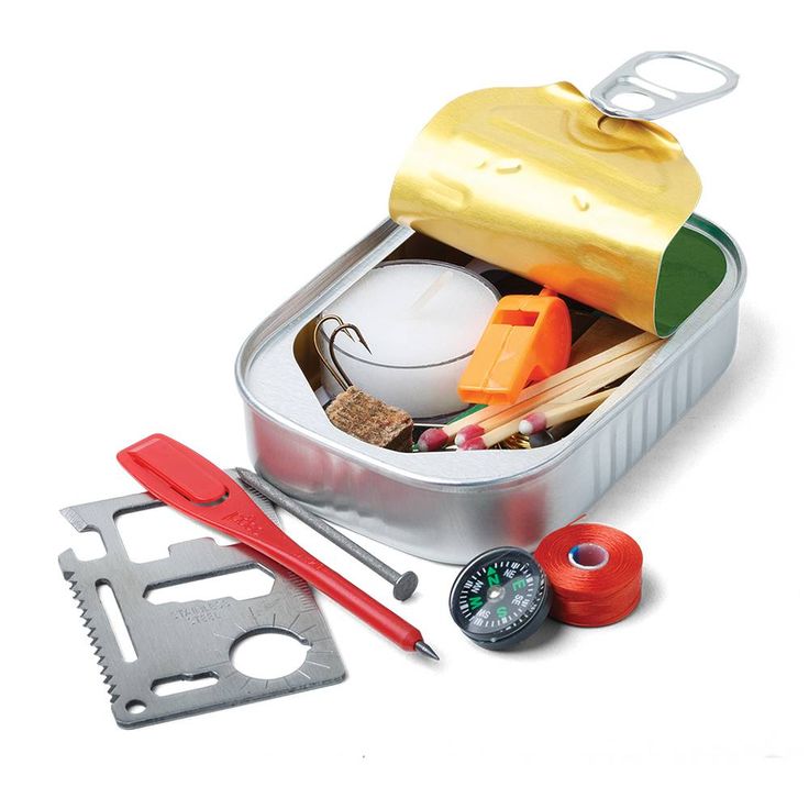 an open tin with scissors and other items in it