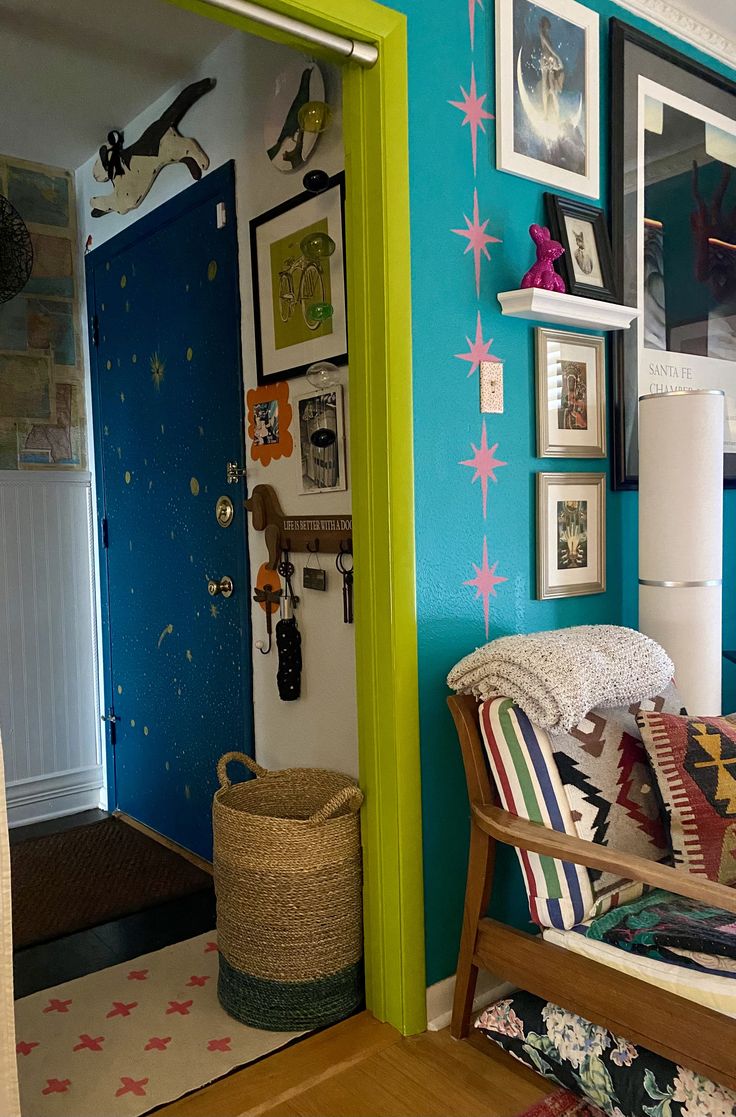 a living room with blue walls and pictures on the wall, including a rocking chair