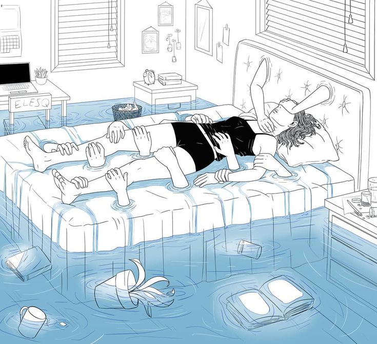 a woman laying on top of a bed in a flooded room next to a tv