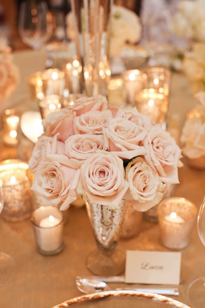 a table topped with lots of flowers and candles