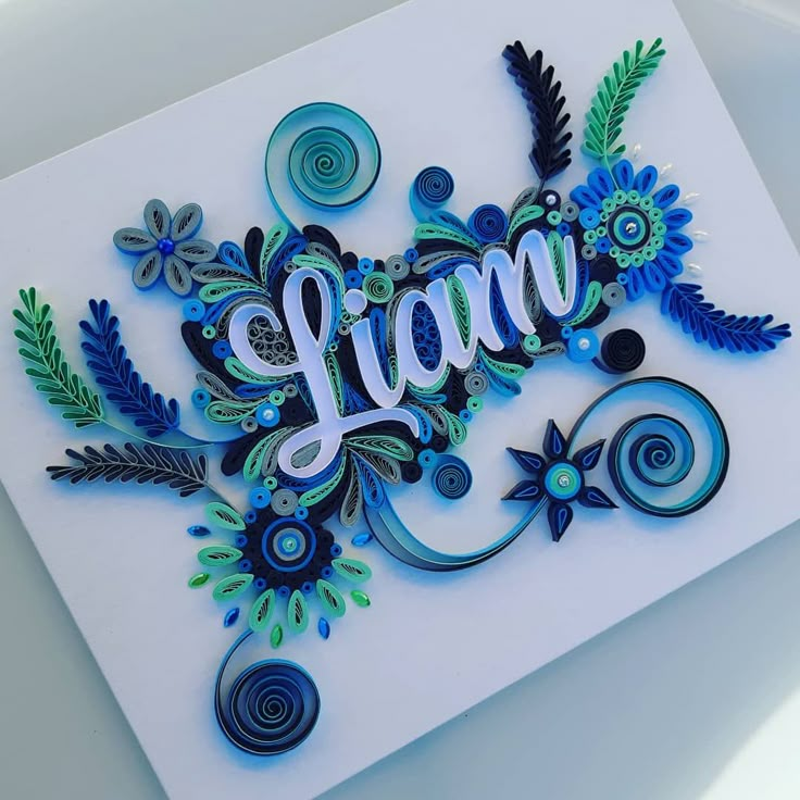 a handmade card with the word lan on it, surrounded by flowers and swirls