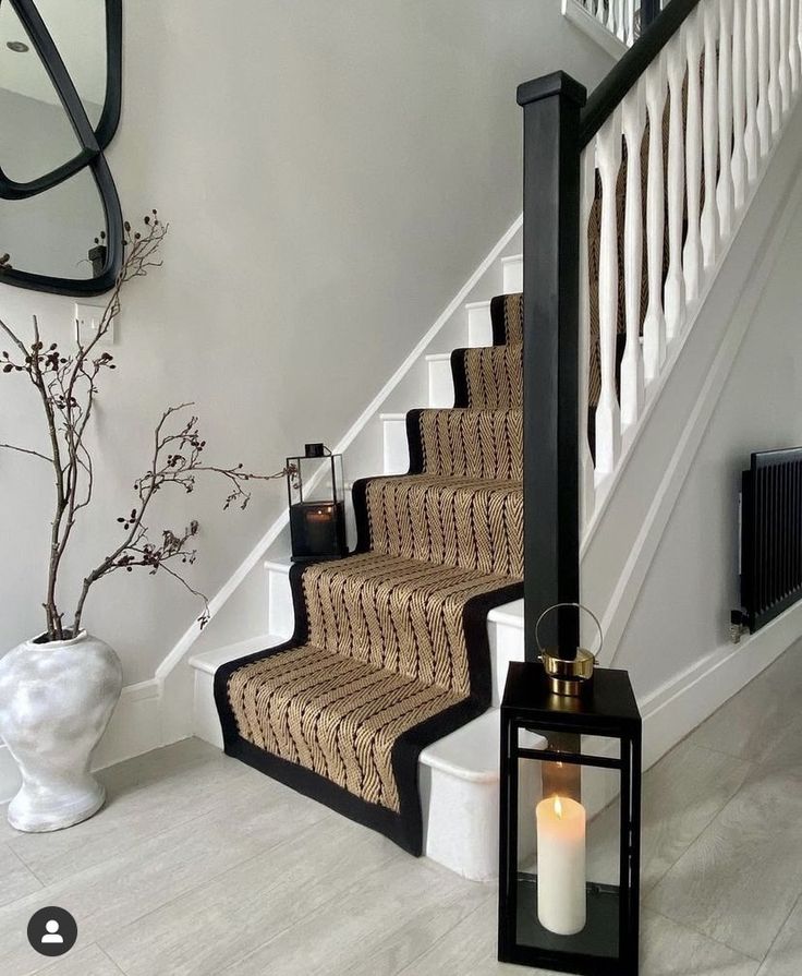 a candle is sitting on the stairs next to a mirror