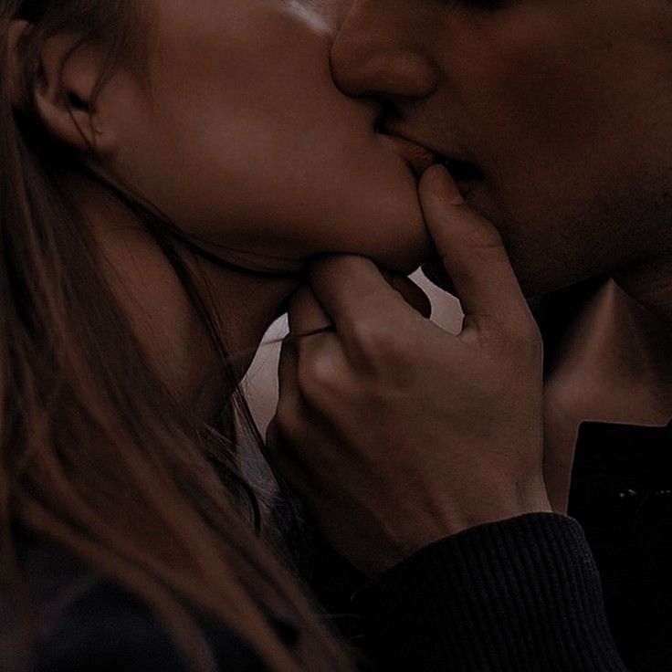 a man and woman kissing each other with their noses close together