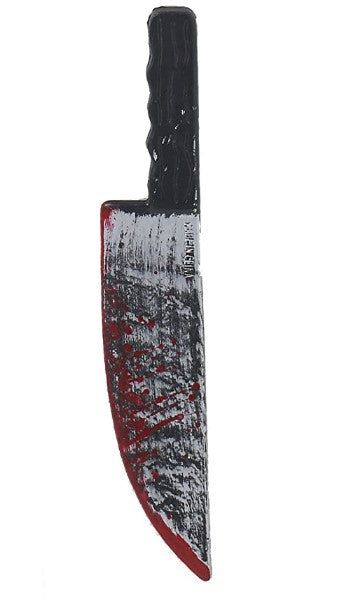 a knife that is on top of a white surface with black and red paint over it