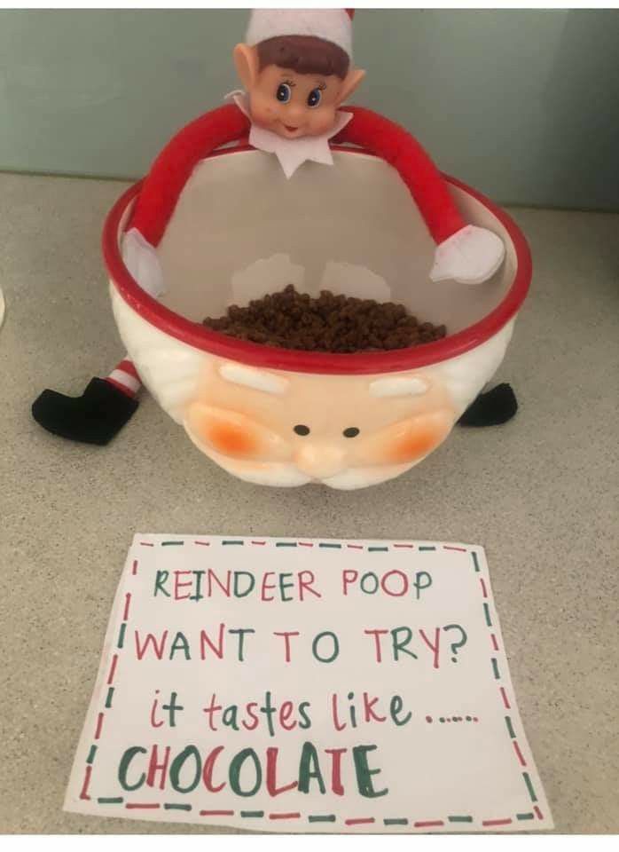 an elf is sitting in a bowl filled with chocolate and the sign says, reindeer poop want to try it tastes like chocolate