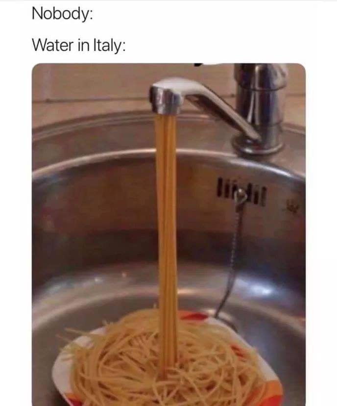 a sink that has noodles in it and water running from the faucet to the bowl