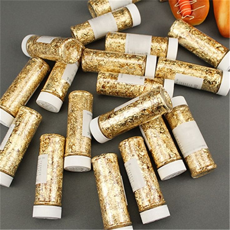 gold and white crackers are laid out on a table next to tomatoes, carrots, and peppers