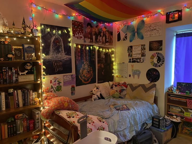 a bedroom decorated with lights and posters on the wall, bookshelves, and bed