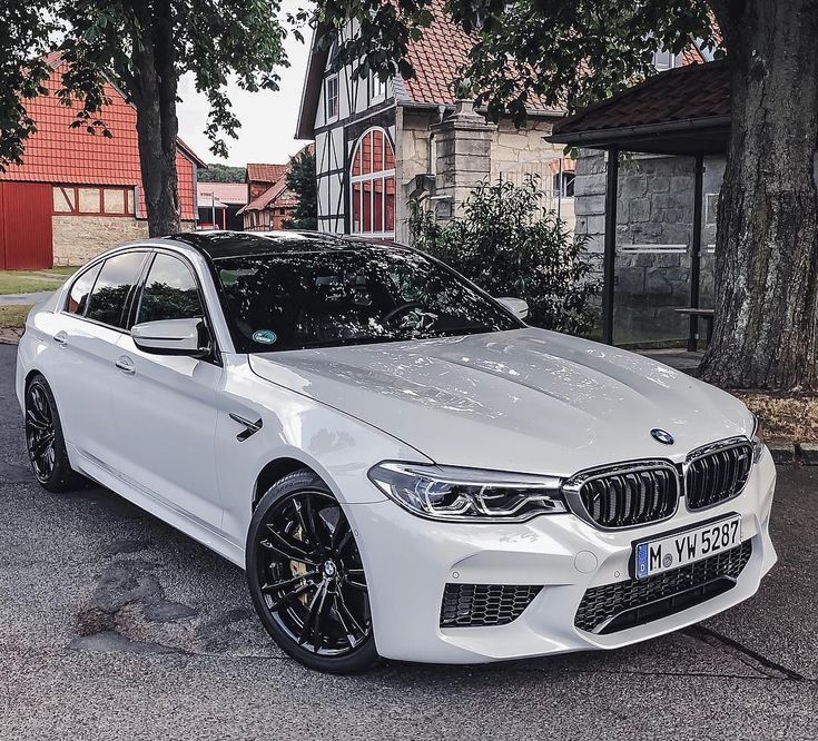 a white car parked in front of a house