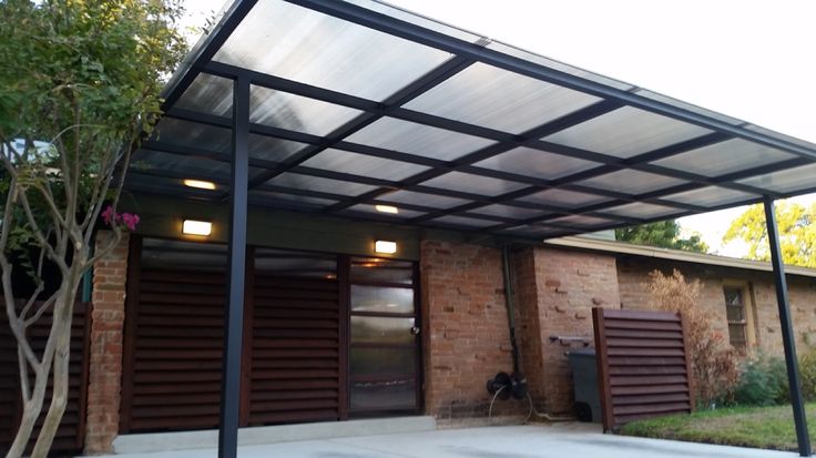 an outdoor covered patio area with brick walls and doors