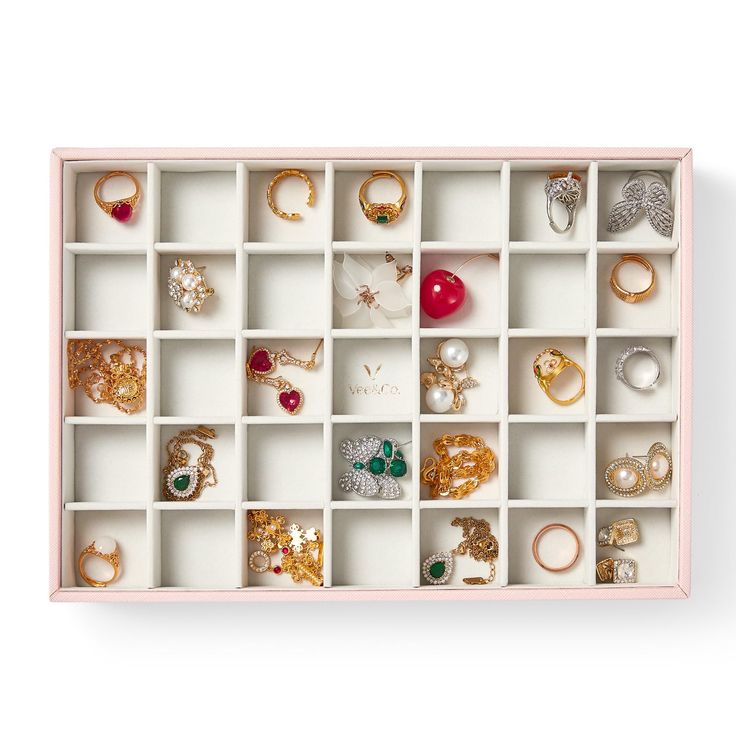 a pink box filled with lots of different types of rings