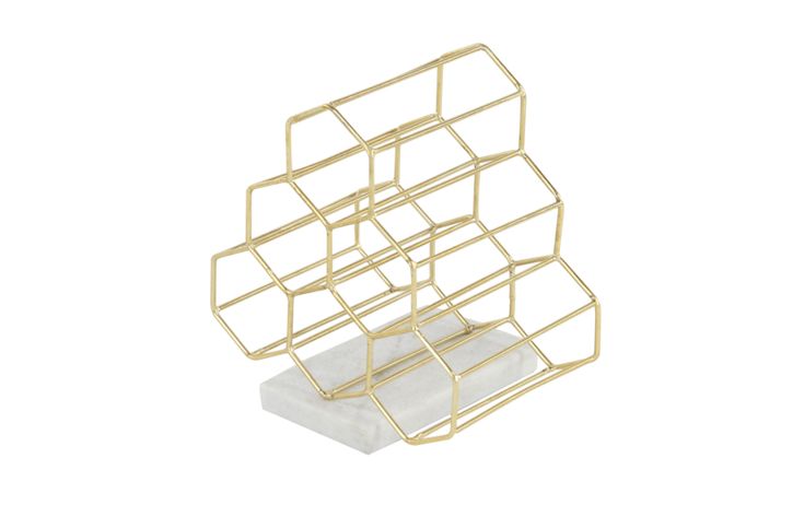 a gold metal object that is on a white surface and has been placed in the shape of a cube