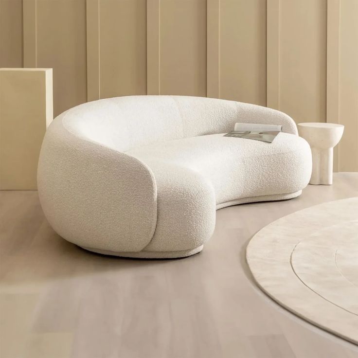 a white couch sitting on top of a wooden floor