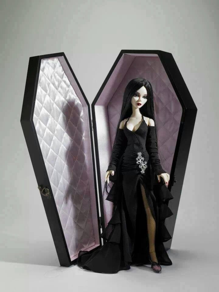 a doll is standing in front of a black and white box with an open door