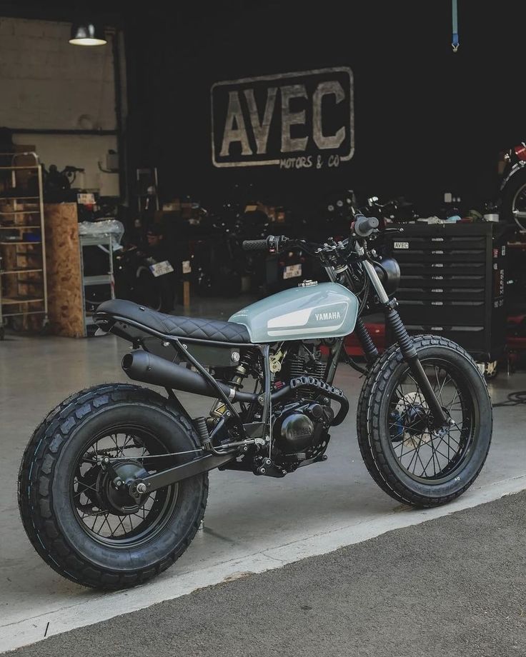 a motorcycle parked in front of a garage