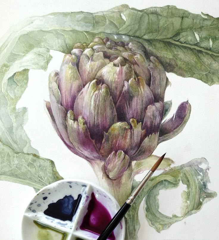 a painting of an artichoke with watercolor paints and a brush in front of it