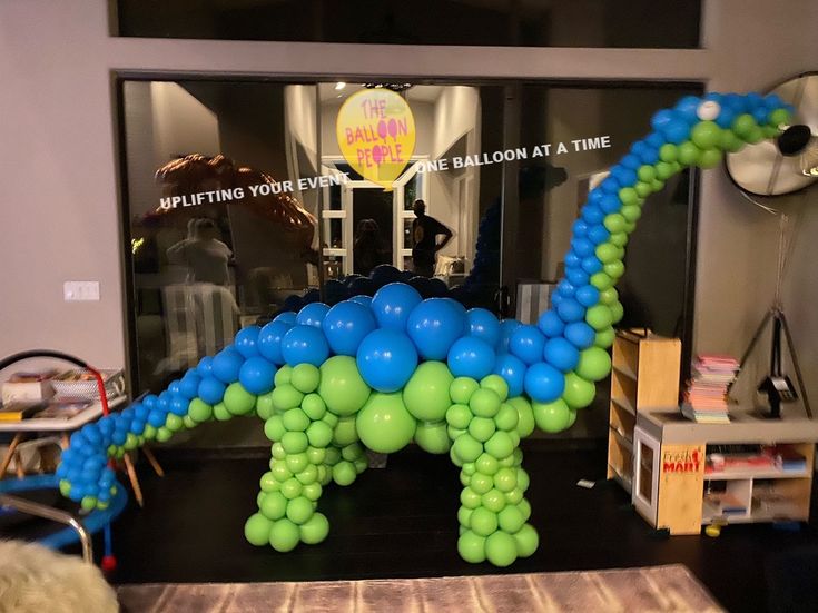 an inflatable dinosaur balloon sitting on top of a table