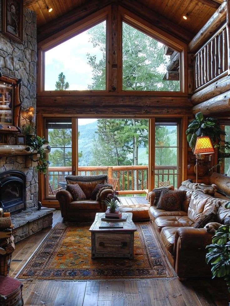 a living room filled with furniture and a fire place next to a stone wall covered in windows