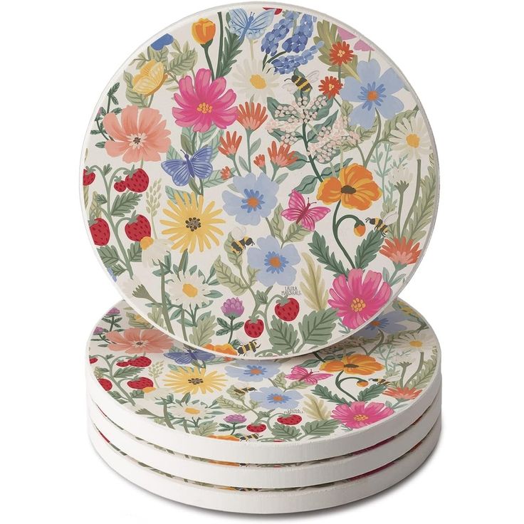 four coasters with colorful flowers on them