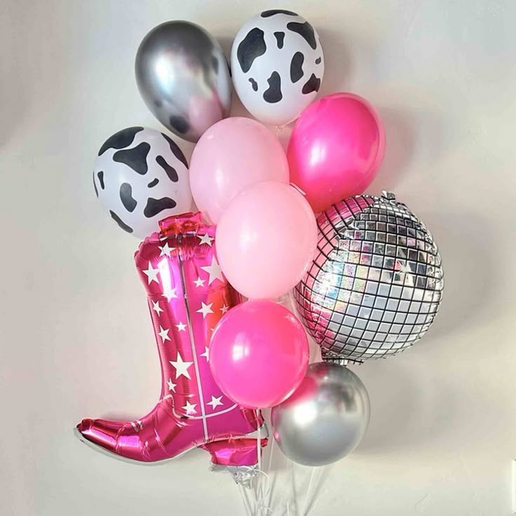 a bunch of balloons that are in the shape of a cowgirl boot and some disco balls