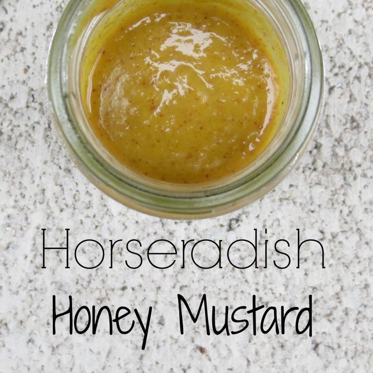 a jar filled with honey mustard sitting on top of a counter