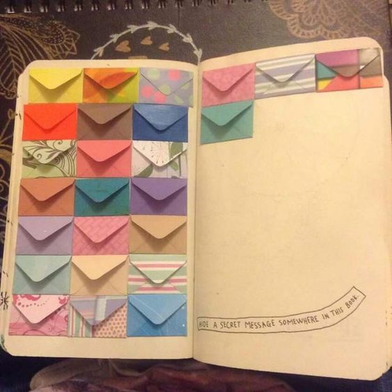 an open book with many different colored envelopes