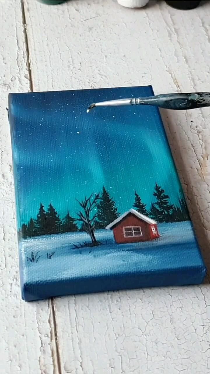 a painting of a house in the snow with a paintbrush on it's side