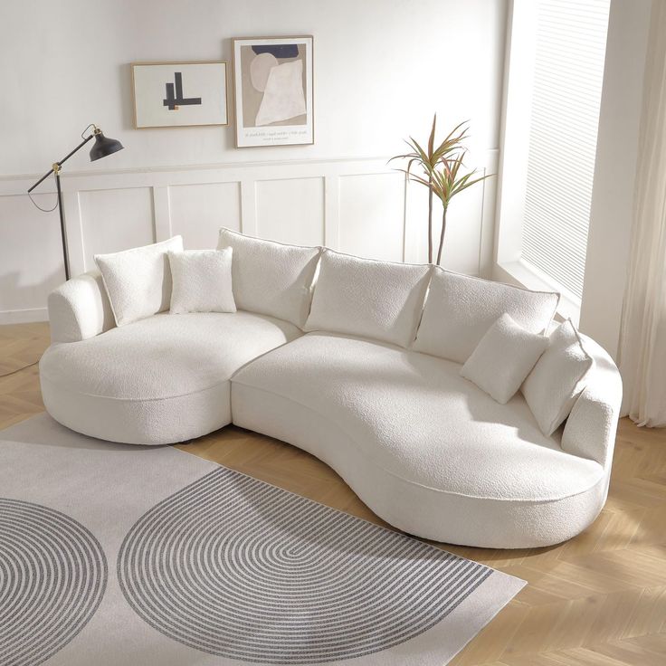 a large white couch sitting on top of a hard wood floor